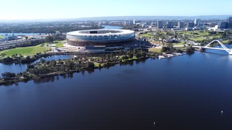 Drone-Aerial-View-flying-up-over-Optus-Stadium-and-Matagarup-Bridge-in-Perth,-Western-Australia