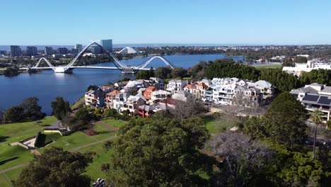 Drone-Aerial-View-descending-down-over-East-Perth-foreshore-park-with-Matagarup-Bridge-and-Swan-River