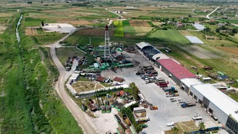 Oil-well-inside-industrial-factory-with-farm-land-near-by