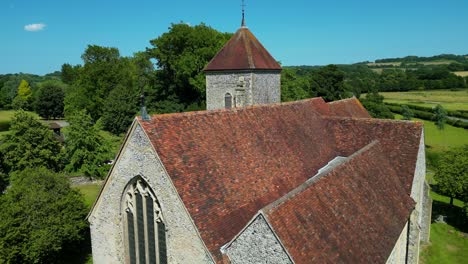 A-descending-boom-shot-of-the-west-wall-and-window-of-St-Lawrence-the-Martyr-church-in-Godmersham