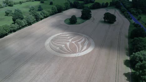 Aerial-view-approaching-mysterious-Warminster-crop-circle-design-with-cloud-shadow-passing-across-rural-farmland