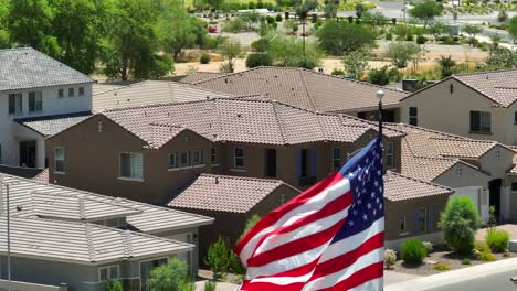 American-flag-waving-in-front-of-houses-in-housing-development-in-Southwest-USA