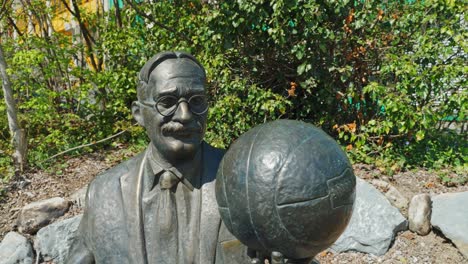 Close-Dolly-of-James-Naismith-statue-holding-a-basketball-at-the-International-Basketball-Federation-Headquarters-in-Switzerland