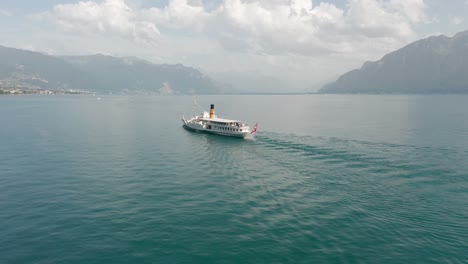 Cinematic-aerial-of-a-beautiful-cruise-ship-on-Lake-Geneva,-Switzerland