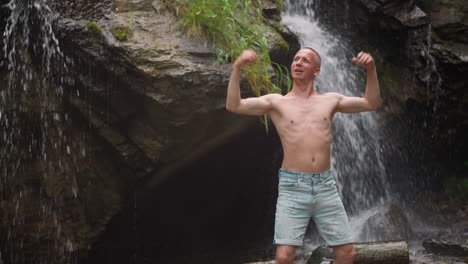 Man-enjoys-vibrations-of-wild-nature-power-near-waterfall