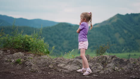 Kleines-Mädchen-In-Lila-Kleidung-Denkt-Auf-Einem-Hügel-Im-Öko-Resort