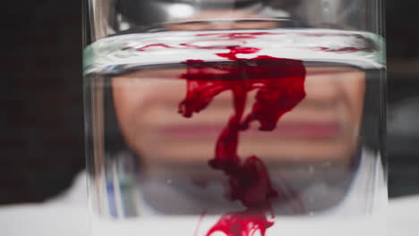 Red-patterns-of-blood-flow-in-liquid-scientist-does-test