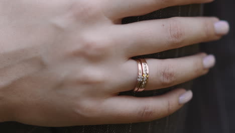 Lady-with-gold-wedding-ring-on-finger-strokes-arm-of-husband