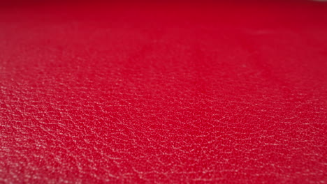 Crimson-color-cow-leather-material-as-background-macro-view