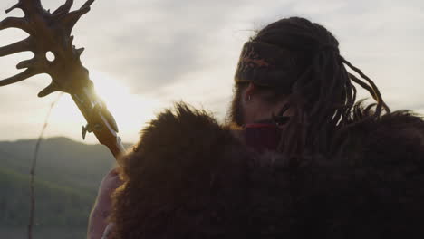 Man-with-dreadlocks-and-fur-cape-plays-tovshuur-in-valley