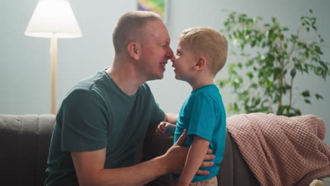 man-plays-with-child,-dad-and-son-rub-their-noses