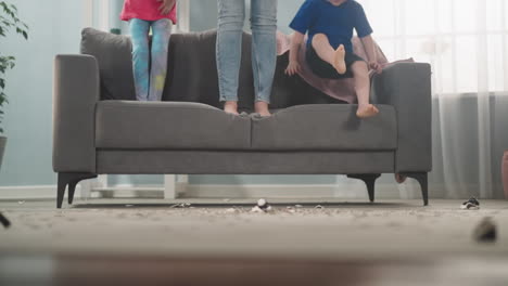 Little-boy-gets-down-of-sofa-jumping-amazed-by-coins-amount