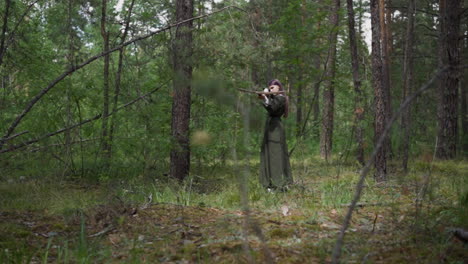 Girl-archer-shoots-crossbow-with-soft-arrow-in-fir-forest