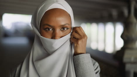 African-American-woman-covers-face-with-hijab-on-waterfront