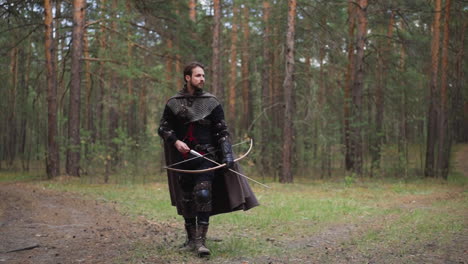 knight-in-armor-walks-through-forest-with-bow