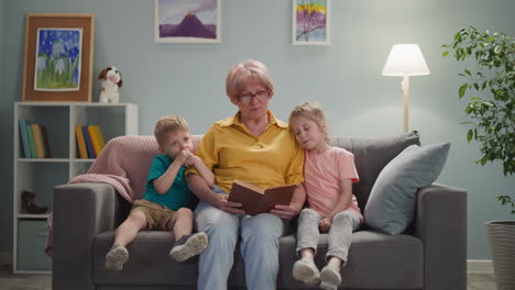 cute-old-lady-with-glasses-reads-a-book-to-children