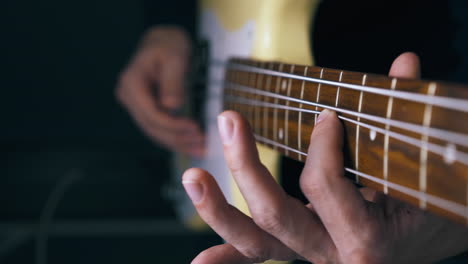 teacher-performs-pitch-shift-technique-on-white-bass-guitar