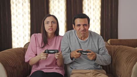 Competitive-Indian-couple-playing-video-games