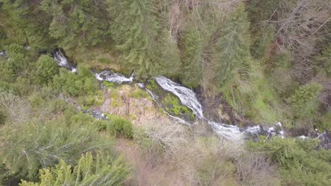Looking-down-on-Rausor-Waterfall,-Romania-from-drone-overhead