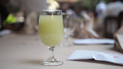 Close-up-bokeh-shot-of-a-freshly-poured-drink-in-a-glass-on-a-table