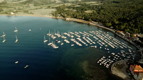 Tuscan-beach-and-boat-harbor-docks-rows-of-yacht-ships,-italy,-aerial