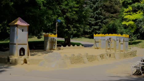Children's-playground-with-a-sand-and-castle-at-Türkenschanzpark-in-Vienna-during-a-sunny-day-at-noon-in-slow-motion