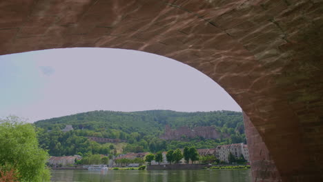 Heidelberg-view-under-Karl-Theodor-Brücke-bridge,-river-neckar,-water-reflection-on-a-sunny-day