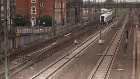 ICE,-Intercity-Express-train-enters-into-train-station,-static-slow-motion-shot