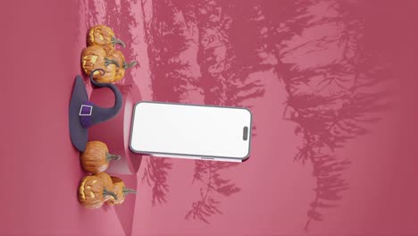 Empty-smartphone-mockup-template-with-pink-background-and-halloween-decoration