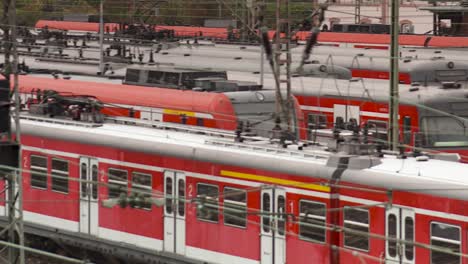 Parked-red-Deutsche-Bahn,-DB-trains-in-Frankfurt,-Germany,-panning-right