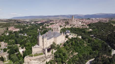 Aerial-wide:-Alcázar-de-Segovia-with-Cathedral-in-backdrop,-highlighting-historical-allure,-Spain