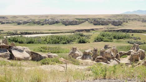 Rock-eroded-into-hoodoos-and-river-in-Writing-on-Stone-Park,-Alberta