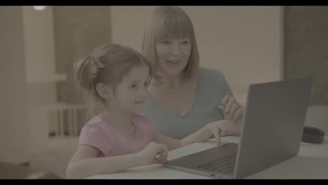 Portrait-of-nice-granny-and-grandchild-using-laptop-making-video-calls-waving-hi-hello