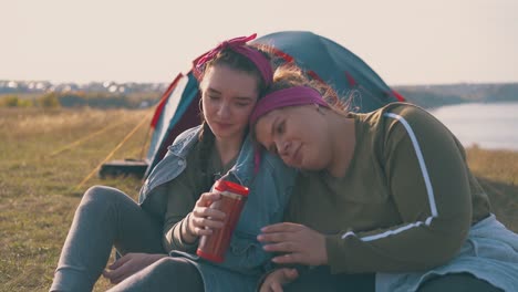 girl-hikers-have-romantic-date-in-calm-camp-at-sunset