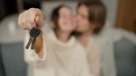 Blurred-footage-couple-in-living-room-show-keys-from-first-house