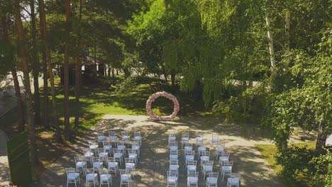 wedding-venue-with-pink-flower-garland-in-park-aerial-view