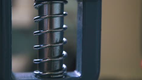 Modern-silver-press-machine-detail-moves-in-workshop-closeup