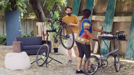 Couple-rectifying-bicycles-in-home-yard