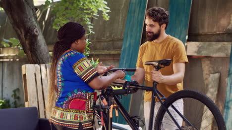 Couple-adjusts-bicycle-on-repair-stand