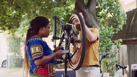 Active-couple-fixing-bicycle-outside