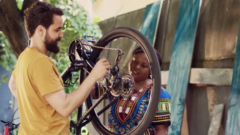 Interracial-couple-greasing-bike-wheels