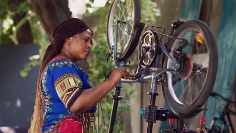 Woman-examining-modern-bicycle-in-yard