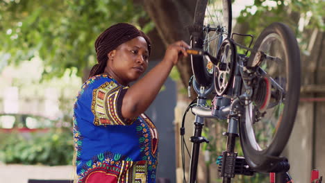 Woman-holding-bike-pedal-for-maintenance