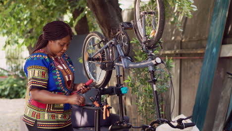 Female-prepares-tools-for-broken-bicycle