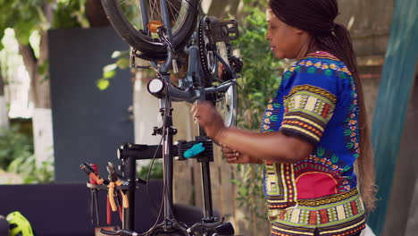 Woman-adjusting-damaged-bicycle-wheel