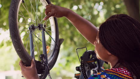 Woman-repairing-bicycle-with-wrench