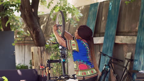 Woman-detaching-damaged-bicycle-wheel
