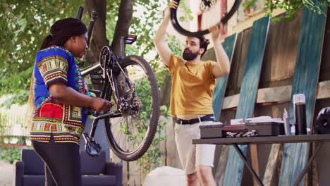 Multiracial-couple-fixes-broken-bicycle