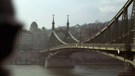 Captivating-footage-of-a-picturesque-bridge-in-Budapest,-bathed-in-warm-sunlight,-as-seagulls-flutter-around,-enhancing-the-serene-atmosphere