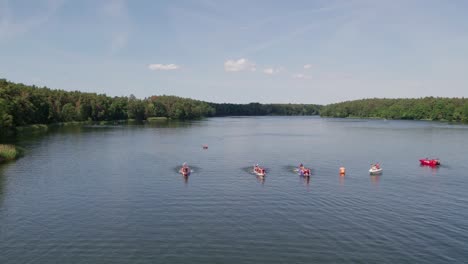Dragon-boats-racing-on-a-lake,-front-view,-drone-shot